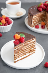 Layered honey chocolate cake with glaze and fresh raspberries on top. Delicious chocolate cake.