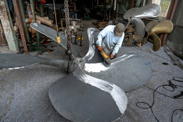 Workers repair propellers for fishing boats in Rach Gia City, Kien Giang, Vietnam