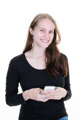 Portrait of smiling young blonde caucasian woman using mobile phone texting on white background