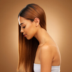 Fototapeta premium Hair care, beauty and profile in studio of woman for growth and color shine or healthy texture. Aesthetic female face for haircare, natural makeup and hairdresser or salon style on brown background