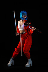 Violinist woman in the cyberpunk costume on the black background.