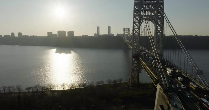 Drone shot following the George Washington bridge, towards sunny New Jersey, USA