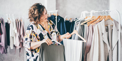  Plus Size Woman Choose Fashioned Dress in Store. Plus size women shopping.