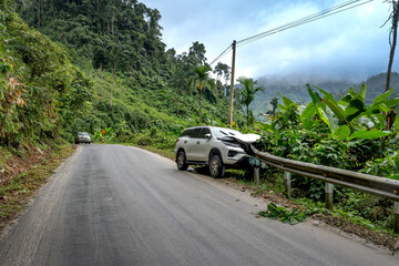 Car accident on the road in the mountains in Tumorong district, Kon Tum province, Vietnam - obrazy, fototapety, plakaty