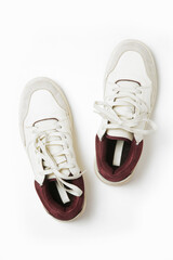 A crisp, clean pair of white leather sneakers isolated on white background, close up studio shot.