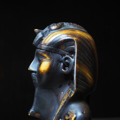 figurine of the Egyptian pharaoh from ebony on a dark background