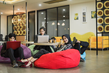Happy diverse team people working and having break time together at creative office lounge, friendly employees group enjoy positive emotions. 