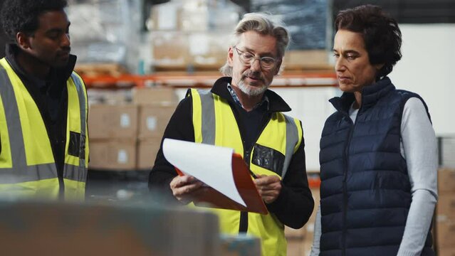 Warehouse handover: Female freight carrier collecting shipment from a distribution center