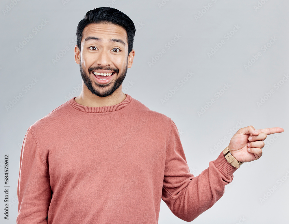 Poster excited, gesture and portrait of indian man pointing at mockup and product placement isolated on whi
