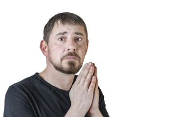 Portrait of an attractive bearded man of European appearance, with a slight gray hair, on an isolated white background. He folded his hands to pray. Expression of emotions of a man.
