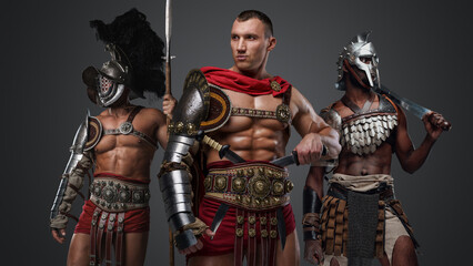 Portrait of muscular greek soldiers fromt past with armor and cold steel.