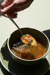 Bowl of soup with vegetable and beef
