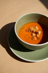 Tomato soup in a bowl close-up, background