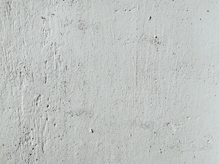 Grunge texture of an old weathered plaster surface. Concrete gray wall background with scratches and cracks.