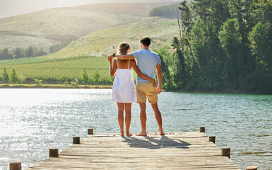 Couple on jetty by the lake, travel and relax together with nature and hug outdoor, love with care...