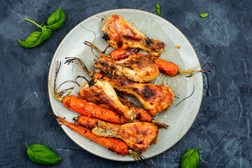 Roasted chicken drumstick with carrots.