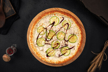 Freshly baked chicken pizza with zucchini and balsamic sauce