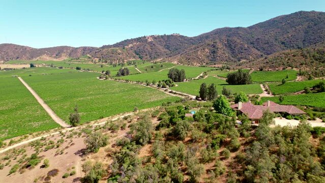 Luxurious Hilltop Mansion With An Outdoor Pool Surrounded By Verdant Vineyards In Cachapoal Province, Chile. wide aerial