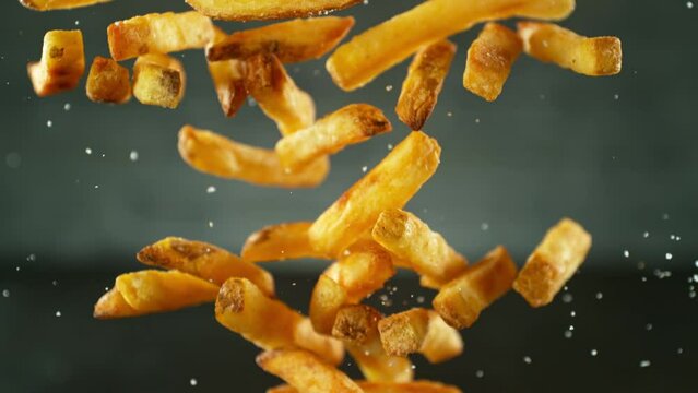 Super Slow Motion Shot of Falling Fresh French Fries. Filmed on High Speed Cinematic Camera at 1000 fps.