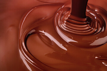 pouring chocolate background. cocoa syrup flowing forming ripples