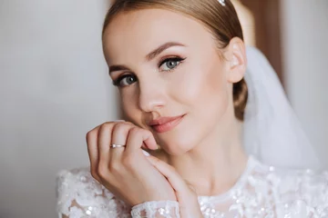 Wall murals Music store Beautiful bride with a fashionable wedding hairstyle, wedding nude makeup. Close up portrait of young gorgeous bride, posing in room in the wedding morning. High quality photo