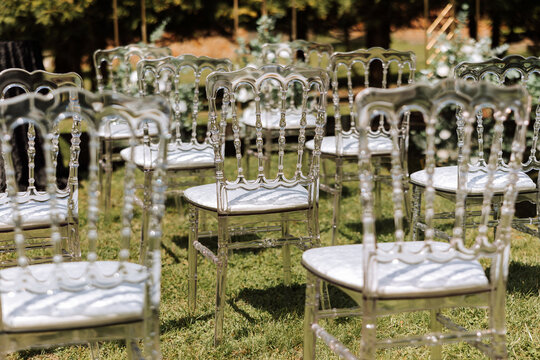 chairs from wedding ceremony. Beautiful wedding set up. Wedding ceremony. decor for wedding. Beautiful outdoor wedding ceremony set up with wooden folding chairs