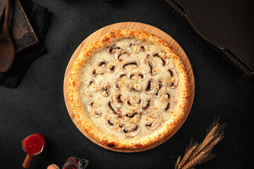 Top view on gourmet pizza with mushrooms and cheese