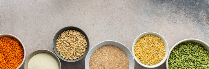 Various grain cereals in bowls banner, top view