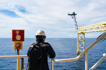 The bridge extends to release gas or a burning flame on an offshore platform.