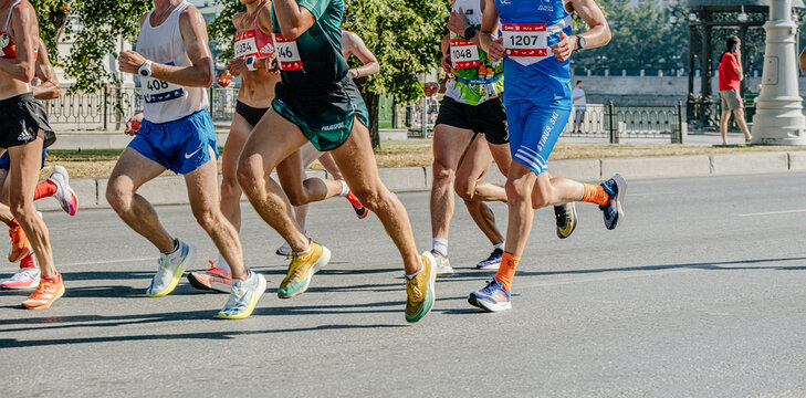group male and female runners athletes running marathon, running clothes Nike and Adidas, sports editorial photos
