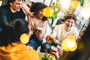 Group of happy people drinking beer sitting at table pub restaurant-Young friends enjoying together at brewery bar having fun and toasting glasses- Food and beverage lifestyle concept - obrazy, fototapety, plakaty