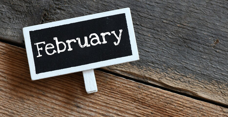 Naklejka premium February on chalk board and table.