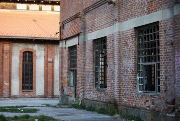 Old abandoned red brick buildings, wooden windows without glass