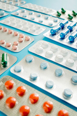 Colorful of tablets and capsules pill in blister packaging arranged with beautiful pattern with flare light. Pharmaceutical industry concept. Pharmacy drugstore