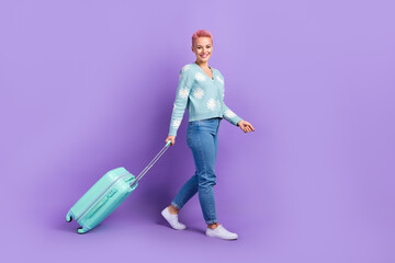 Full body length cadre of experienced adventure tourist youngster girl walk baggage airport registration flight isolated on purple color background