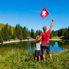 Father and son traveling in Switzerland- Swiss flag
