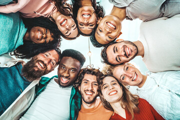 Portrait close up picture of happy faces young friends standing in circle and looking at camera - Millenial diverse people taking selfie photo - Life style concept with guys and girls hugging together