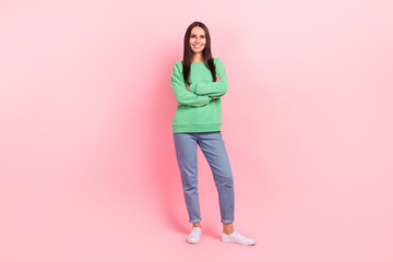 Full body photo of cheerful pretty young lady wear stylish outfit green jumper denim jeans promo banner shopping isolated on pink color background