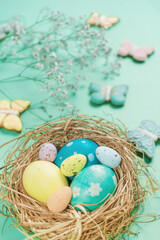 Easter banner on a green background. Easter eggs and cookies in the shape of a rabbit and a butterfly. Easter concept.
