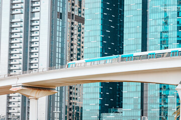 metro train in Dubai, gliding smoothly and efficiently through the city downtown center among skyscrapers