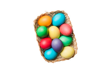 Basket of colorful Easter eggs isolated on white background. Easter basket filled with colored eggs top view holiday concept