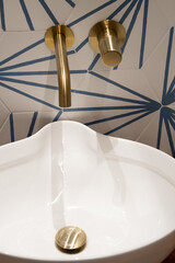 closeup photo of a modern hand basin with gold details. Interior design concept.