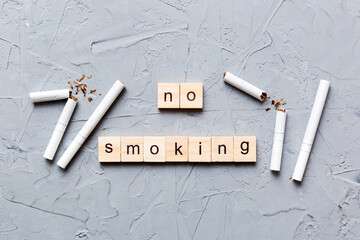 Cigarette And Wooden Blocks, Broken cigarette on table background, No Tobacco Day with hourglass,...