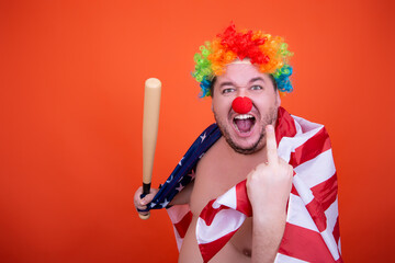 Funny fat man in a clown costume. Joy and anger.