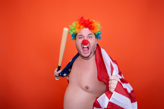 Funny fat man in a clown costume. Joy and anger.