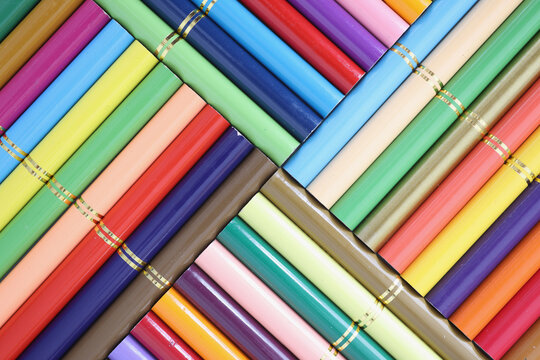 Set of colored pencils stacked in row closeup.