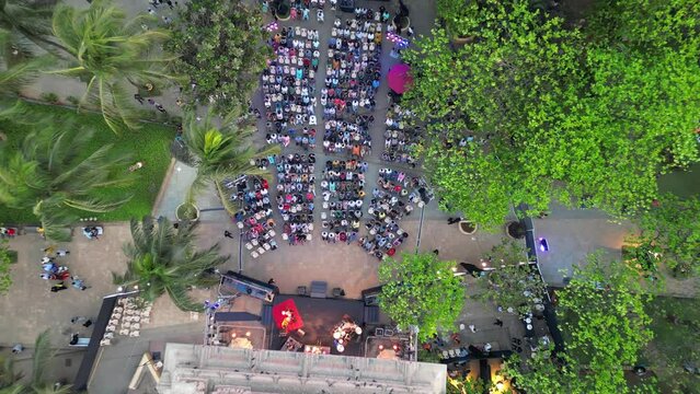 people are sitting and watching the program at  Dadar chow patty beach bird eye view