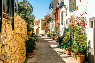 Finestrat, Alicante province, Spain. Beautiful quiet narrow street of small Finestrat village old town at sunny day