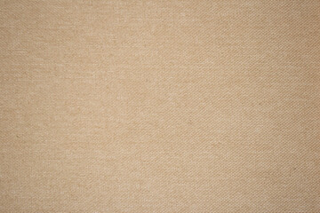 Fototapeta na wymiar A beige fabric background texture full frame