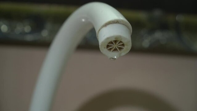 Water flowing from a faucet into a sink